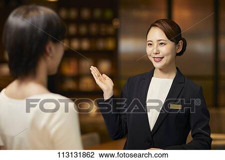 Young woman checking in at hotel View Large Photo Image Stock Image - Young woman checking in at hotel. Fotosearch
