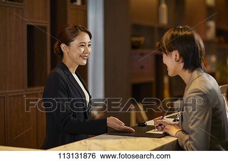 Young woman checking in at hotel View Large Photo Image Stock Photograph - Young woman checking in at hotel. Fotosearch