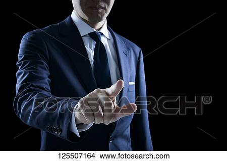Picture - Businessman on black background. Fotosearch