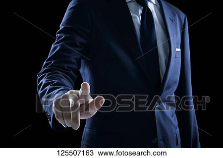 Stock Image - Businessman on black background. Fotosearch