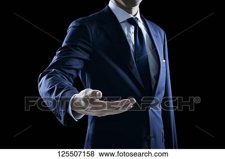 Stock Photo - Businessman on black background. Fotosearch
