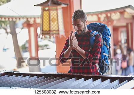 Stock Image - Caucasian man visiting Tokyo, Japan. Fotosearch