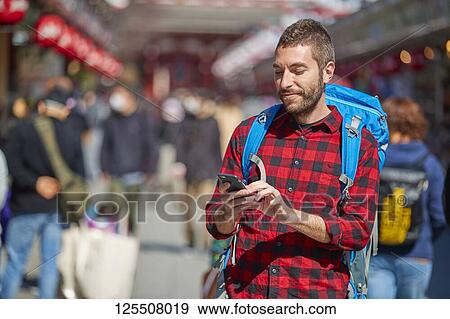 Stock Photo - Caucasian man visiting Tokyo, Japan. Fotosearch