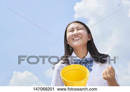 Stock Image - Cheering Japanese junior high schoolgirl. Fotosearch