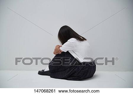 Stock Image - Depressed Japanese junior high schoolgirl. Fotosearch