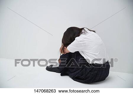 Stock Image - Depressed Japanese junior high schoolgirl. Fotosearch