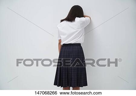 Stock Photograph - Depressed Japanese junior high schoolgirl. Fotosearch