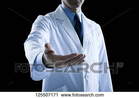 Stock Image - Doctor on black background. Fotosearch