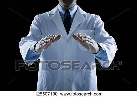 Stock Image - Doctor on black background. Fotosearch