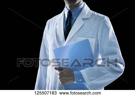 Stock Image - Doctor on black background. Fotosearch