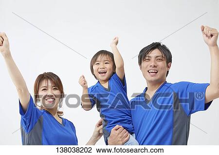 Stock Image - Family Watching A Game And Cheering. Fotosearch