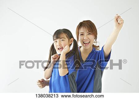 Stock Image - Family Watching A Game And Cheering. Fotosearch