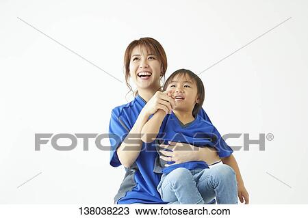 Stock Image - Family Watching A Game And Cheering. Fotosearch
