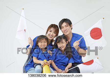 Stock Photograph - Family Watching A Game And Cheering. Fotosearch