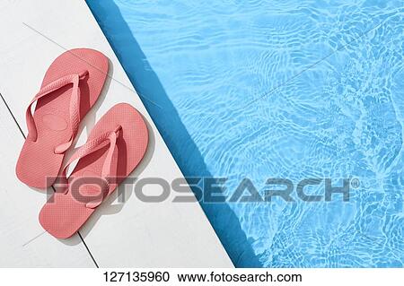 Stock Image - Flip-Flops At The Poolside. Fotosearch