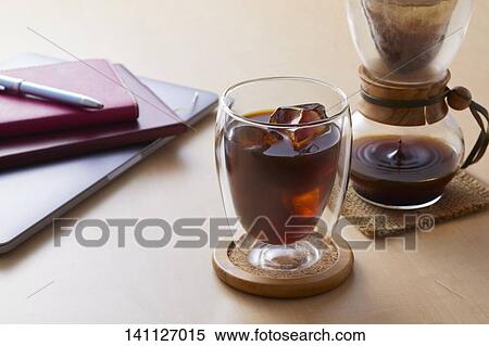 Stock Photography - Glass Of Coffee On The Desk. Fotosearch