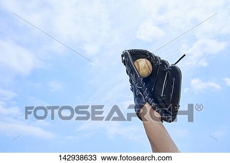 Hand holding baseball against blue sky View Large Photo Image Stock Image - Hand holding baseball against blue sky. Fotosearch
