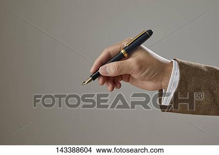 Picture - Hand holding pen. Fotosearch