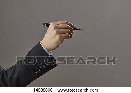 Stock Image - Hand holding pen. Fotosearch