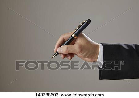 Stock Image - Hand holding pen. Fotosearch
