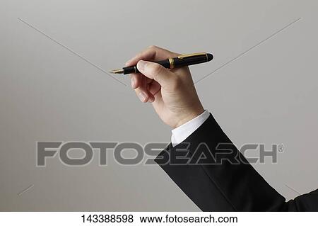 Stock Photo - Hand holding pen. Fotosearch