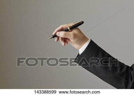 Stock Photo - Hand holding pen. Fotosearch