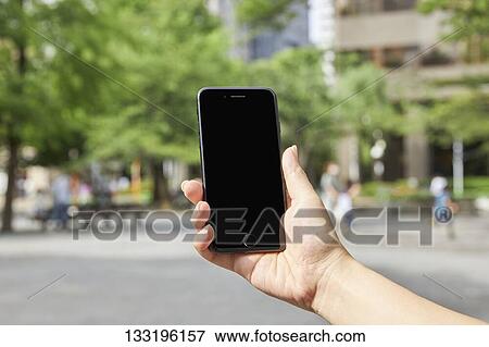 Hand Holding Smartphone View Large Photo Image Stock Photo - Hand Holding Smartphone. Fotosearch