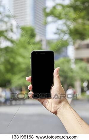 Hand Holding Smartphone View Large Photo Image Stock Photo - Hand Holding Smartphone. Fotosearch