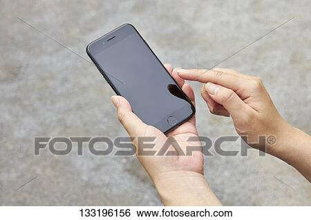Stock Photograph - Hand Holding Smartphone. Fotosearch