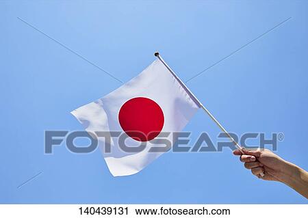 Stock Image - Hand With Japanese Flag. Fotosearch