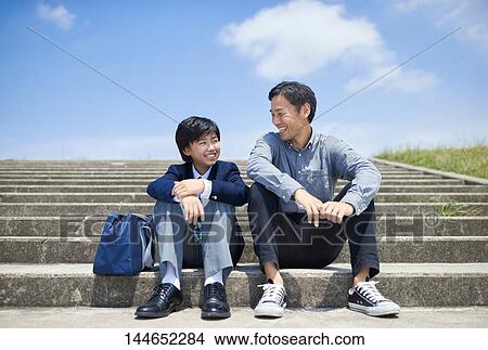 Picture - Happy Japanese father and son outdoors. Fotosearch