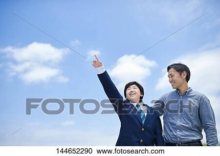 Stock Image - Happy Japanese father and son outdoors. Fotosearch