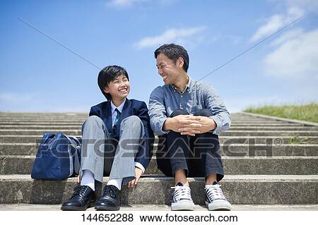Stock Photo - Happy Japanese father and son outdoors. Fotosearch