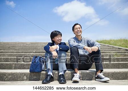Stock Photography - Happy Japanese father and son outdoors. Fotosearch