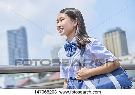 Stock Image - Happy Japanese junior high schoolgirl. Fotosearch