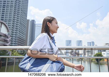 Stock Photograph - Happy Japanese junior high schoolgirl. Fotosearch