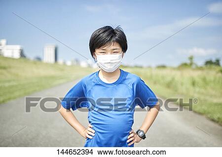 Picture - Happy Japanese teenager enjoying himself outdoors. Fotosearch