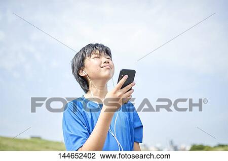Happy Japanese teenager enjoying himself outdoors View Large Photo Image Stock Image - Happy Japanese teenager enjoying himself outdoors. Fotosearch