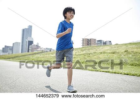 Stock Photo - Happy Japanese teenager enjoying himself outdoors. Fotosearch