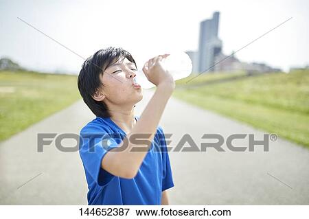 Happy Japanese teenager enjoying himself outdoors View Large Photo Image Stock Photo - Happy Japanese teenager enjoying himself outdoors. Fotosearch