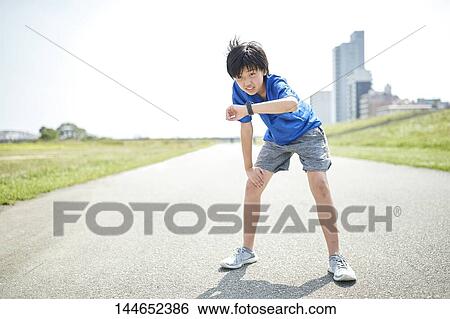 Stock Photograph - Happy Japanese teenager enjoying himself outdoors. Fotosearch