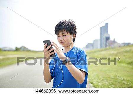 Happy Japanese teenager enjoying himself outdoors View Large Photo Image Stock Photograph - Happy Japanese teenager enjoying himself outdoors. Fotosearch