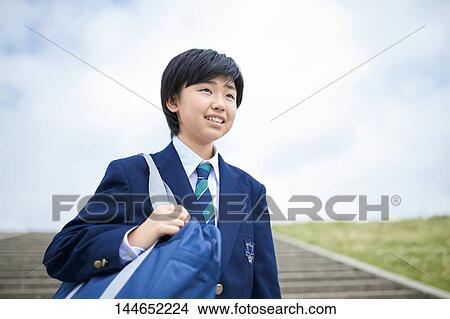 Picture - Happy Japanese teenager outdoors. Fotosearch