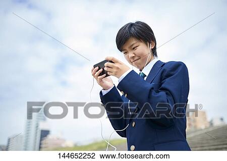 Happy Japanese teenager outdoors View Large Photo Image Stock Image - Happy Japanese teenager outdoors. Fotosearch