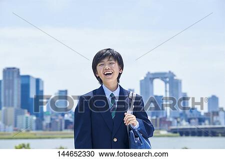 Stock Image - Happy Japanese teenager outdoors. Fotosearch