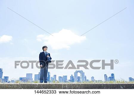 Stock Image - Happy Japanese teenager outdoors. Fotosearch