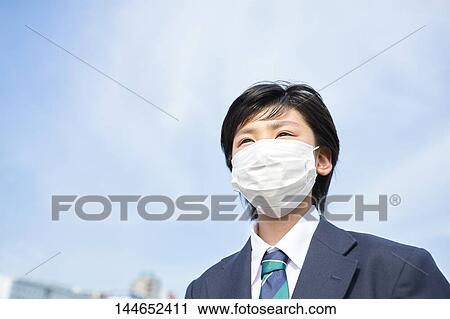 Stock Image - Happy Japanese teenager outdoors. Fotosearch