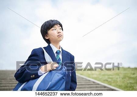 Stock Photo - Happy Japanese teenager outdoors. Fotosearch