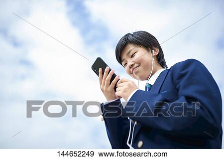 Happy Japanese teenager outdoors View Large Photo Image Stock Photo - Happy Japanese teenager outdoors. Fotosearch