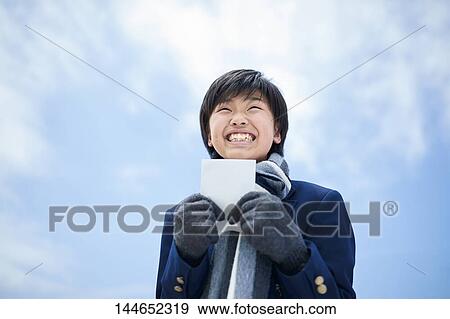 Happy Japanese teenager outdoors View Large Photo Image Stock Photo - Happy Japanese teenager outdoors. Fotosearch